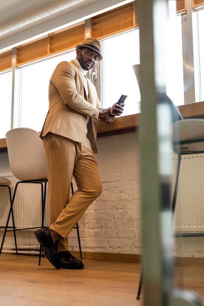 Modern african american man in beige suit