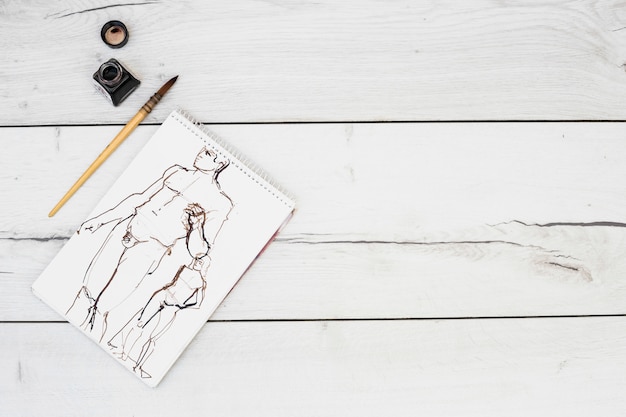 Free photo modern artist concept with notebook and brush