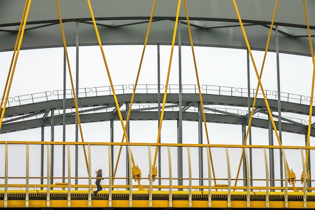 Free photo modern bridge with yellow and grey metal fragments