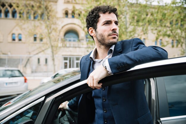 Modern businessman sitting in car