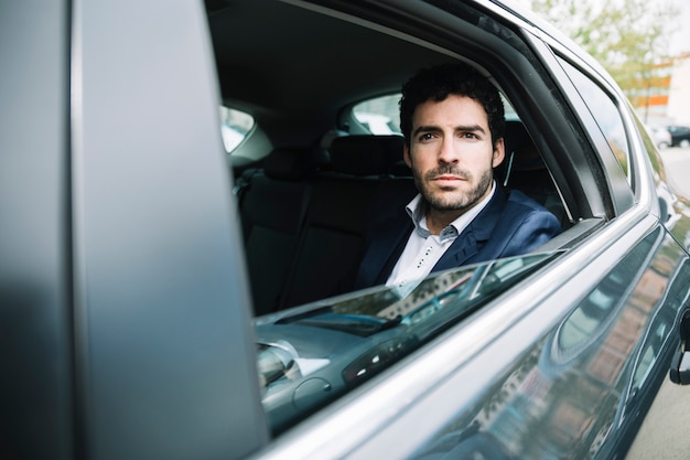 Modern businessman sitting in car