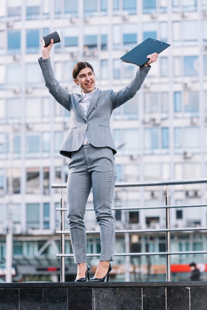 Modern businesswoman celebrating outdoors