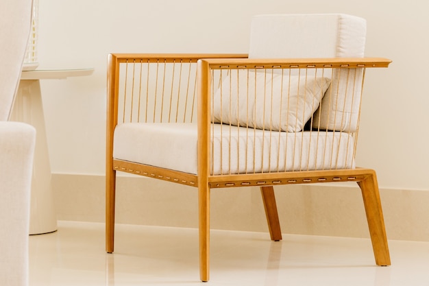 Modern chair with white cushions in a white room