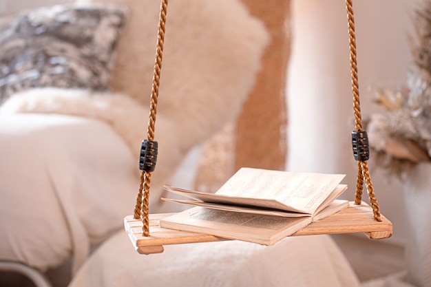 Modern cozy interior of the living room with a hanging swing.