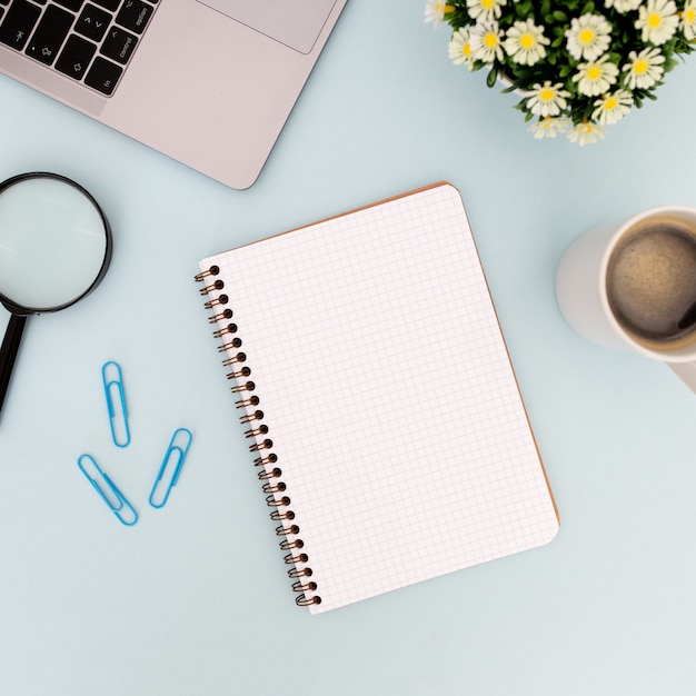 Modern desk with empty notebook for mock up