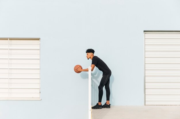 Modern ethnic standing with basketball 