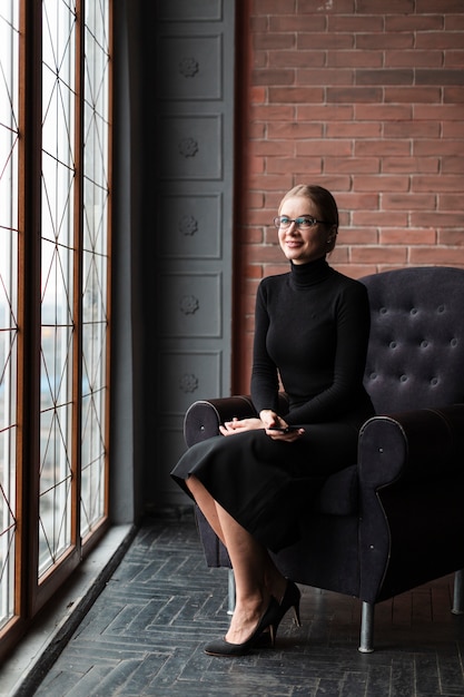 Free photo modern female sitting on couch