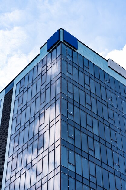 Modern Glass Building Architecture with blue sky and clouds