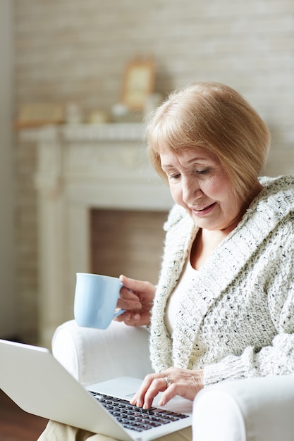 Modern granny chatting via social network