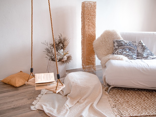 Modern interior of the living room with a hanging swing.