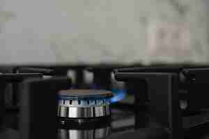 Free photo modern kitchen stove, natural gas burns with a blue flame. household gas consumption. close-up, selective focus