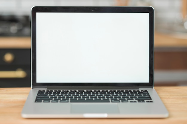 Modern laptop with blank white screen on wooden table