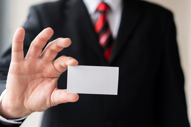 Modern man holding blank business card