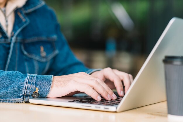 Modern man using laptop in urban environment