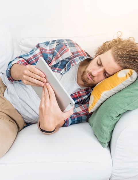 Modern man using table on couch