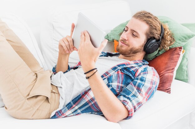 Modern man using table on couch