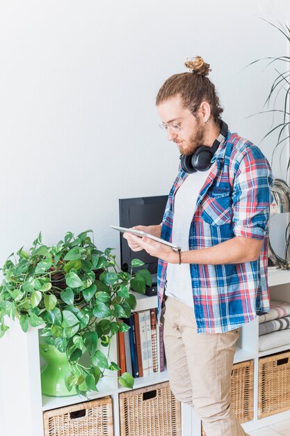 Modern man using tablet at home