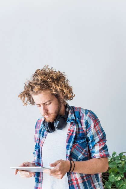 Modern man using tablet at home