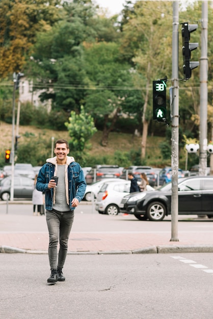 Free photo modern man with coffee cup in urban environment