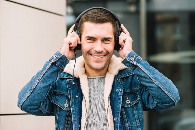 Modern man with headphones in urban environment