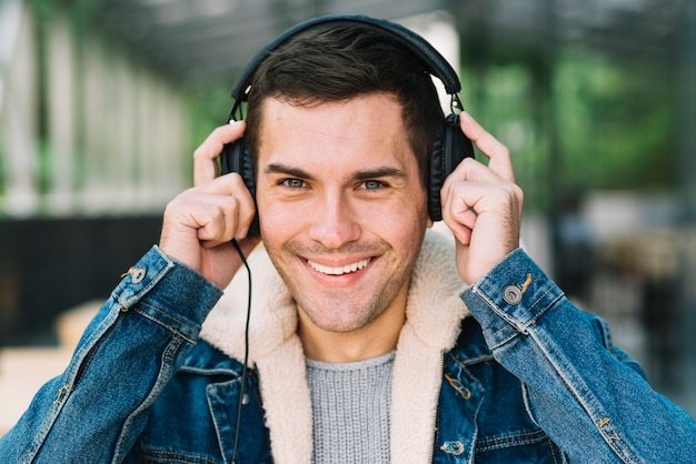 Modern man with headphones in urban environment