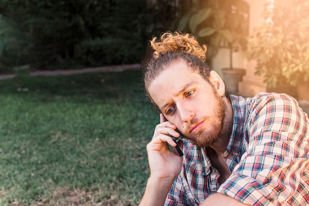 Free photo modern man with smartphone in garden