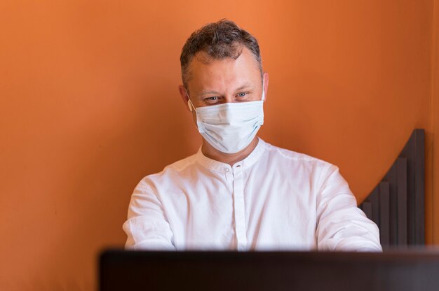 Modern man working with his medical mask on