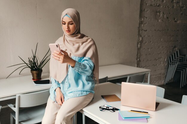 Modern muslim woman in hijab in office room