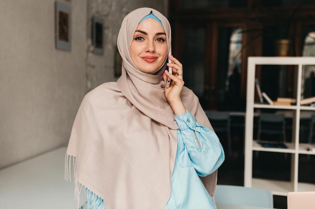 Modern muslim woman in hijab in office room