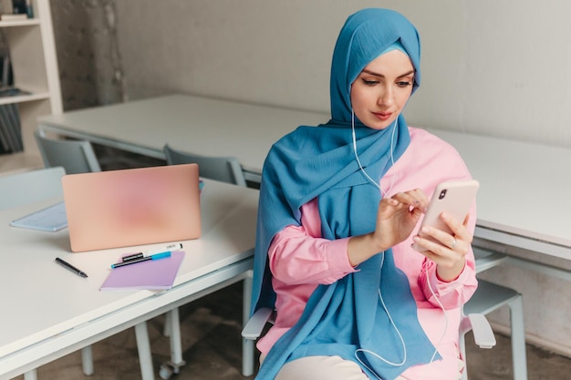 Modern muslim woman in hijab in office room