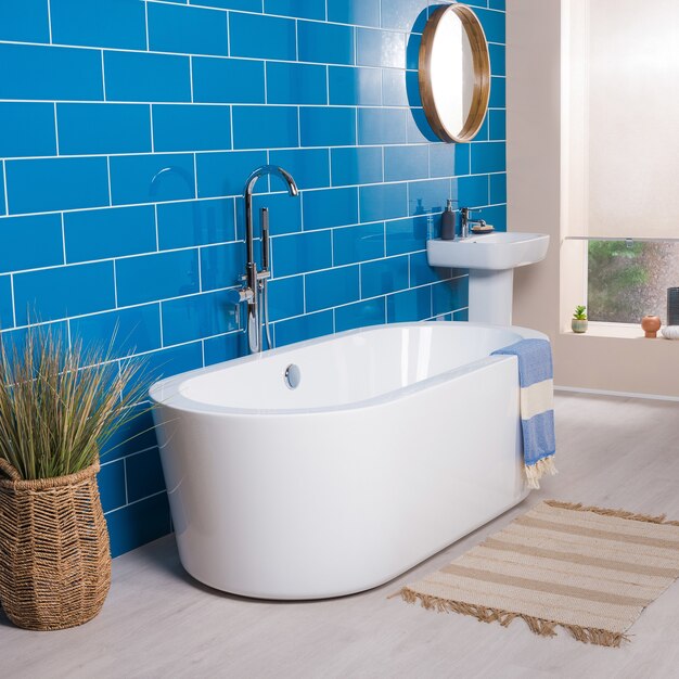 Modern and new steel faucet with the ceramic bathtub  in the bathroom