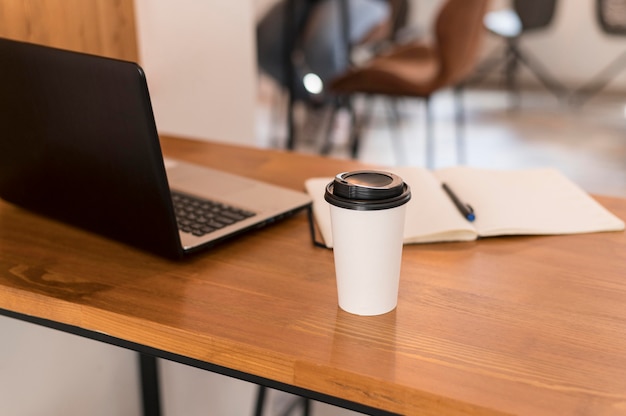 Modern office desk with cup of coffee