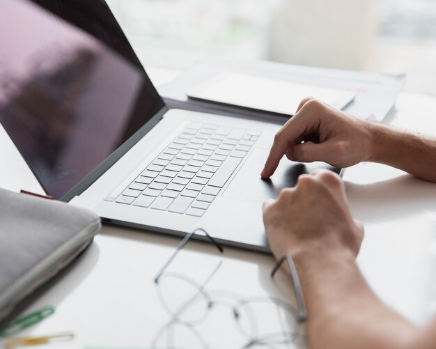 Modern office with laptop and glasses