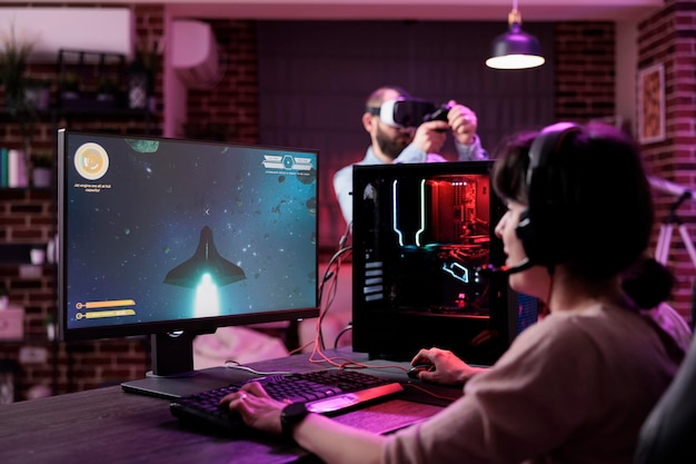 Modern player live streaming video games play on computer, having fun with rpg tournament. Young adult playing online action shooting game with multiple players on pc, shooter challenge.