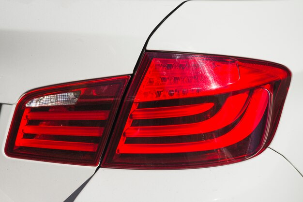 Modern rear light on new matte white automobile