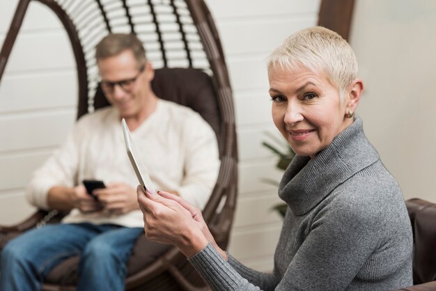 Modern senior couple using wireless devices