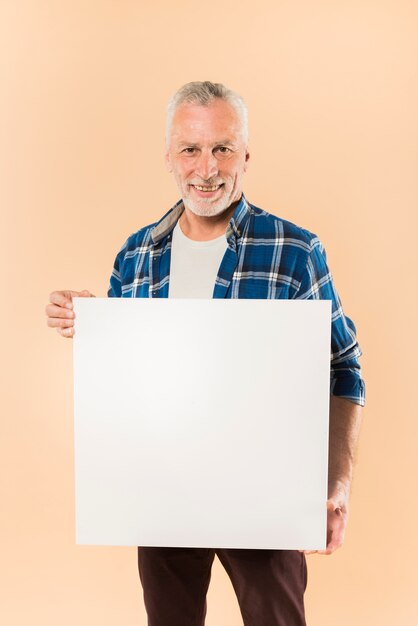 Modern senior man holding board template