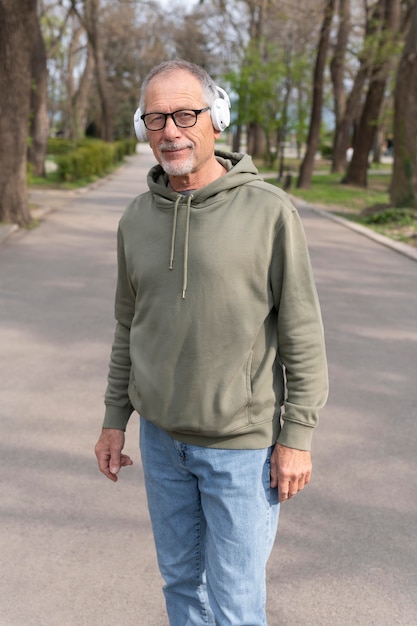 Modern senior man listening to music in a headset