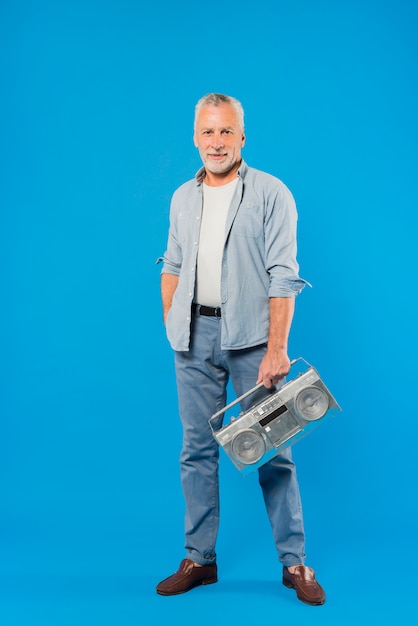 Modern senior man with vintage radio