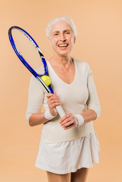 Modern senior woman playing tennis