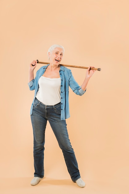 Modern senior woman with cane