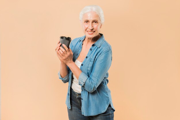 Modern senior woman with coffee cup