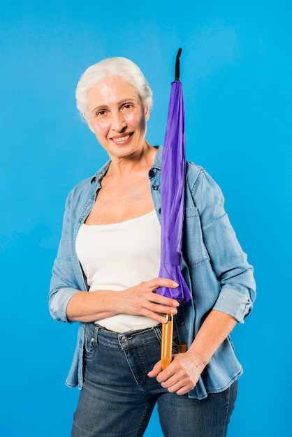 Modern senior woman with umbrella