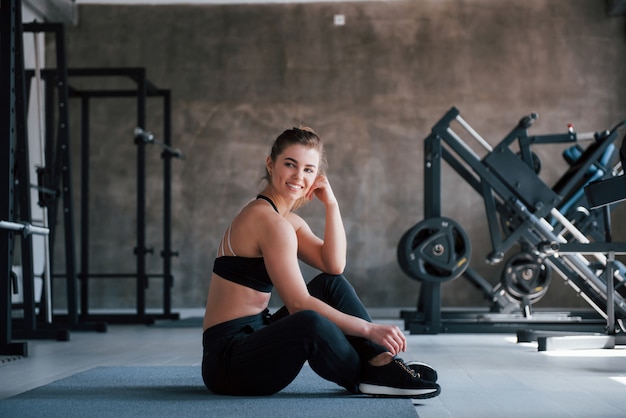 Modern sports. Photo of gorgeous blonde woman in the gym at her weekend time