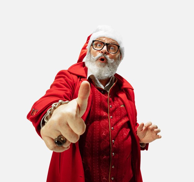 Modern stylish Santa Claus in red fashionable suit and cowboy's hat