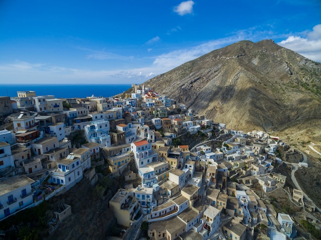 Modern white buildings in Karpathos surrounded by mountains and sea