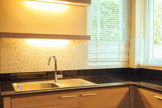 Modern white kitchen sink with morning sun rays