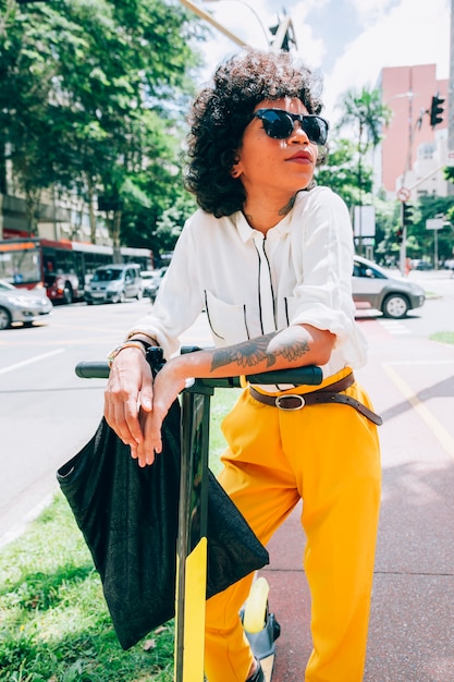 Modern woman in a city with a electric scooter