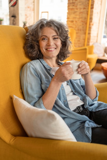 Free photo modern woman enjoying cup of coffee