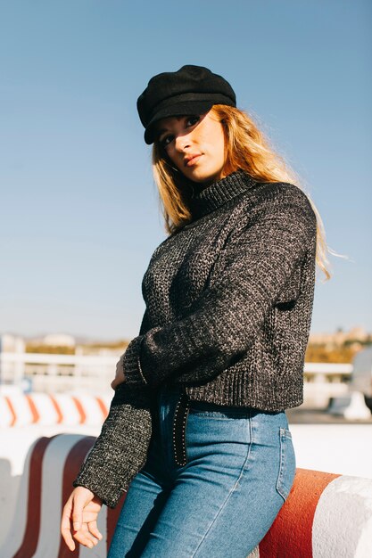 Modern woman leaning against barrier